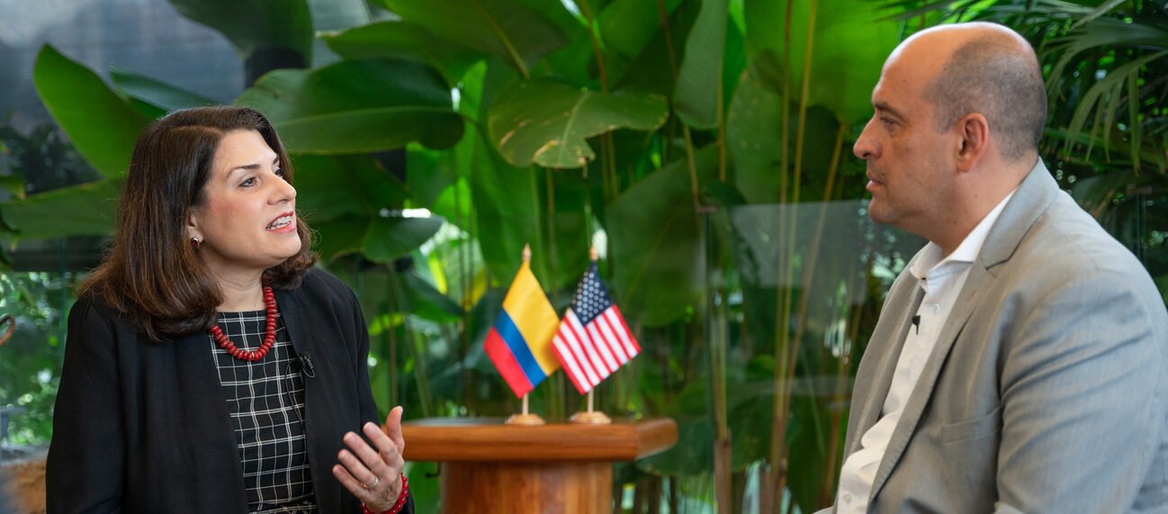 Assistant Secretary Julieta Valls Noyes talks to a Colombian journalist during her visit to Medellin in 2023.